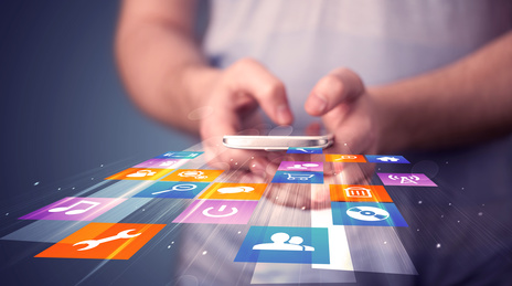 Man holding smart phone with colorful application icons comming out